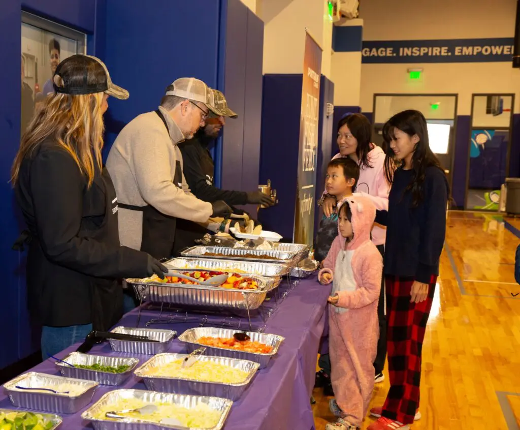 Families enjoying Hunt Fish Feed dinner