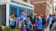 Young Comcast Cares Day volunteers stand outside of Lincoln Elementary School.