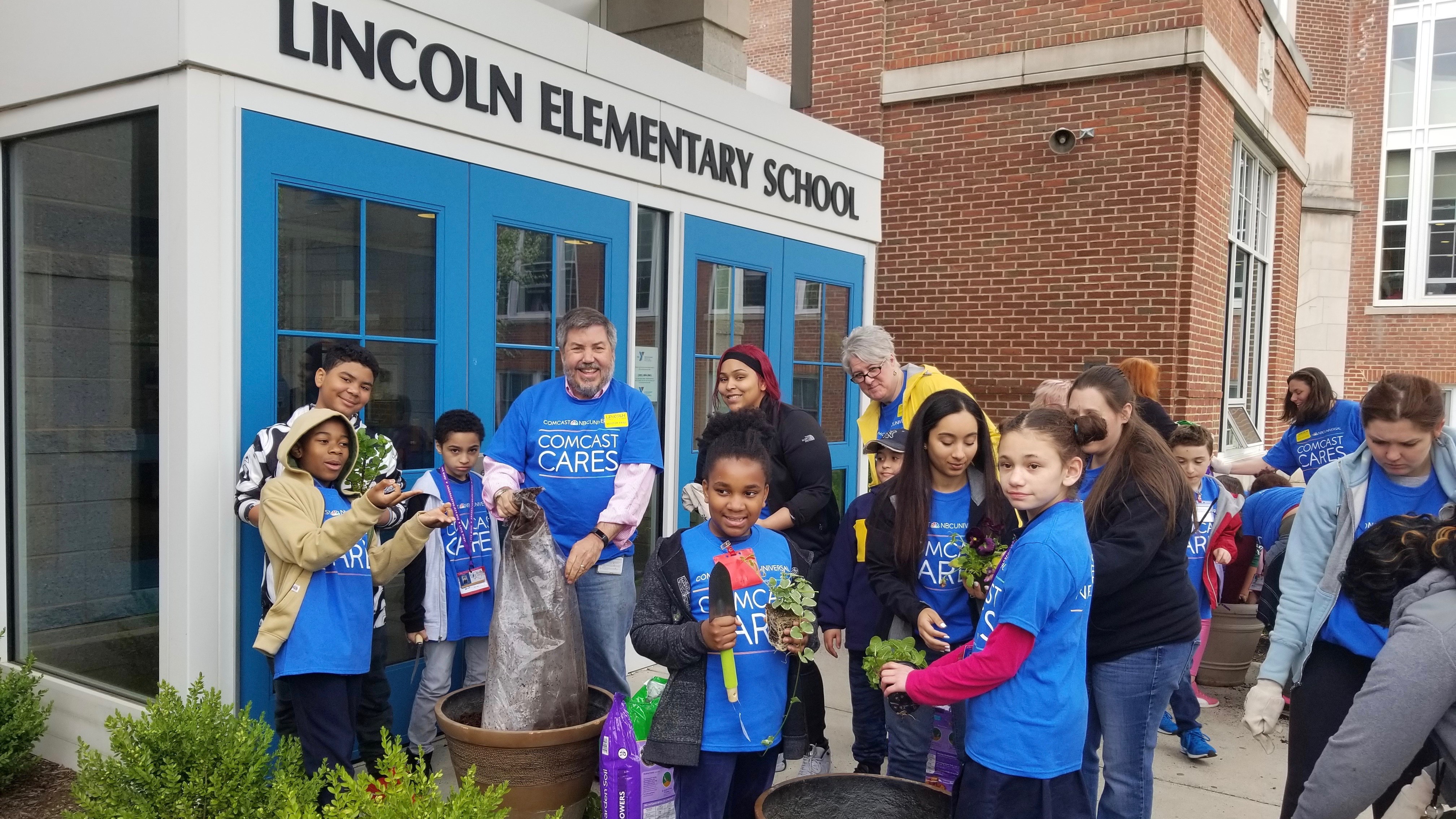 Young Comcast Cares Day volunteers stand outside of Lincoln Elementary School.