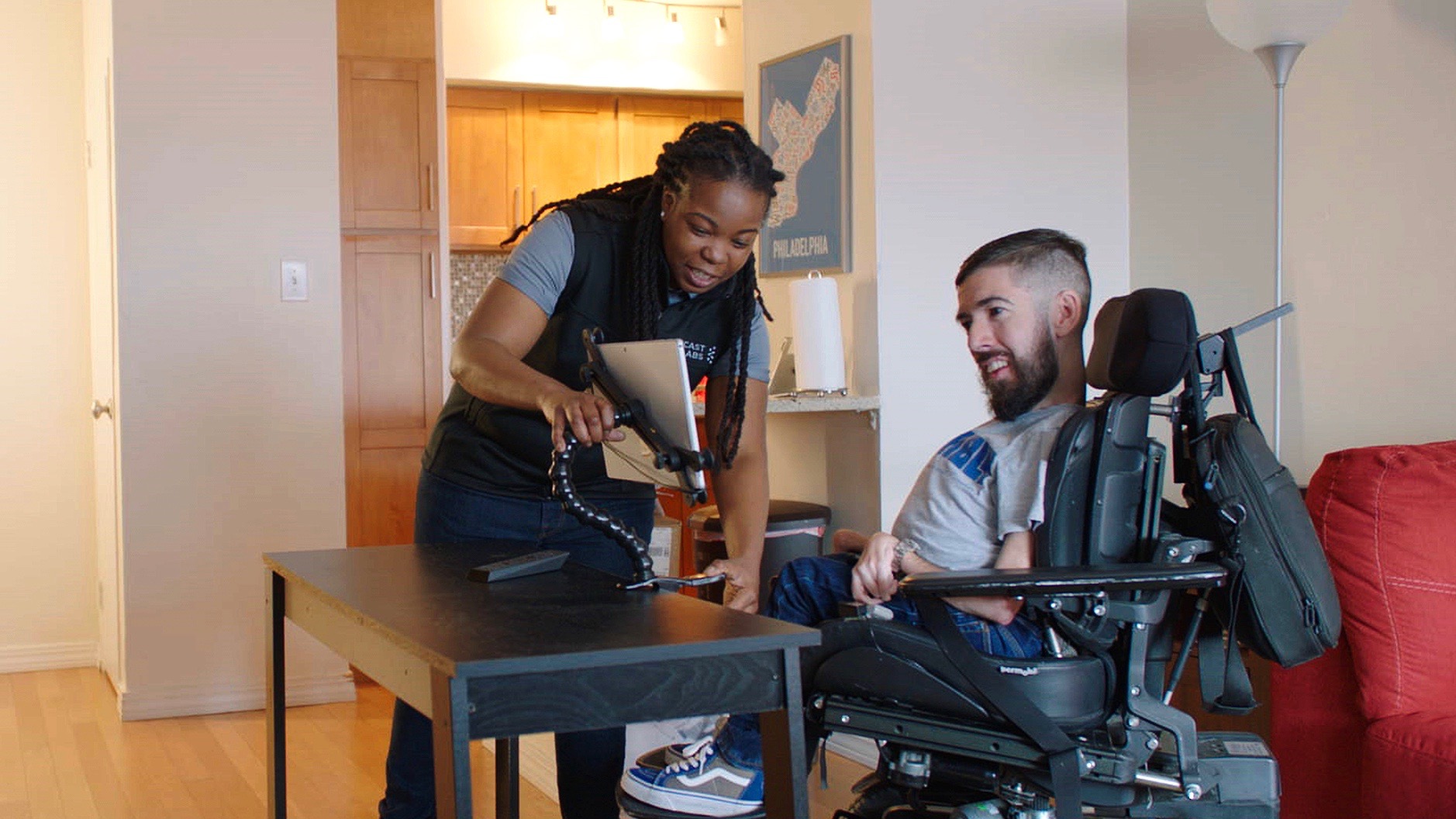 A Comcast Labs technician sets up an eye-control tablet for Jimmy.