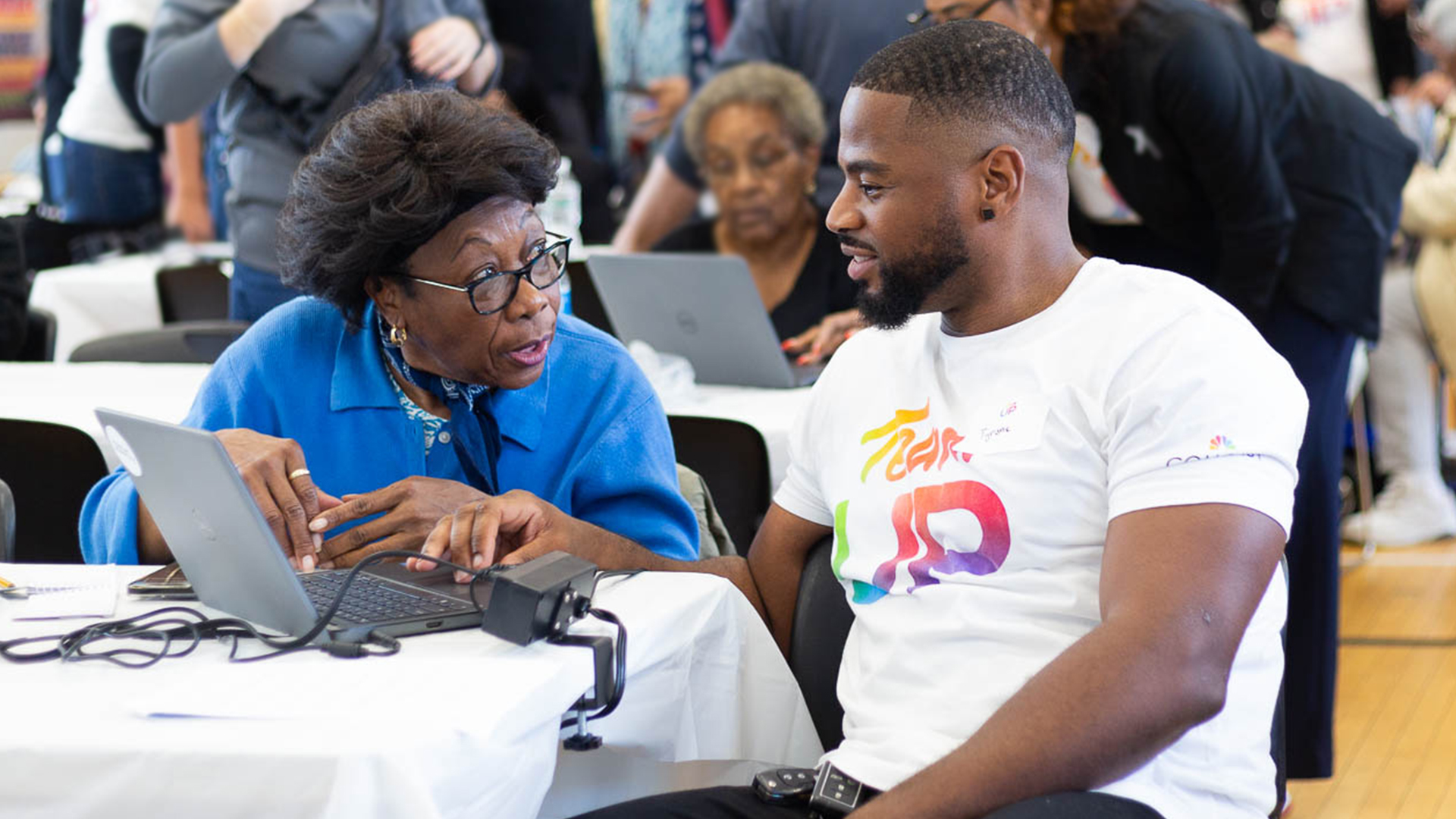 Team Up volunteer helping older woman with laptop