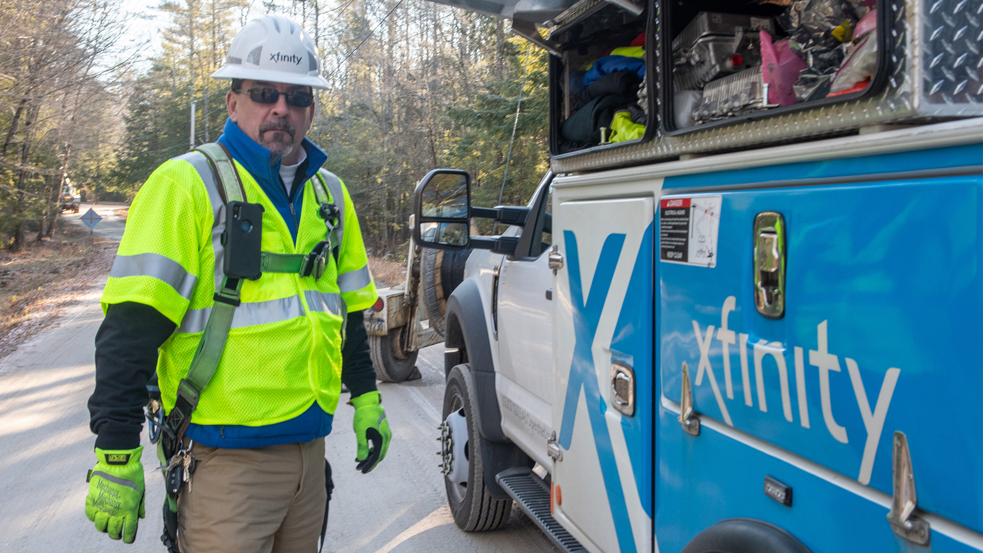 Technician standing next to Xfinity truck