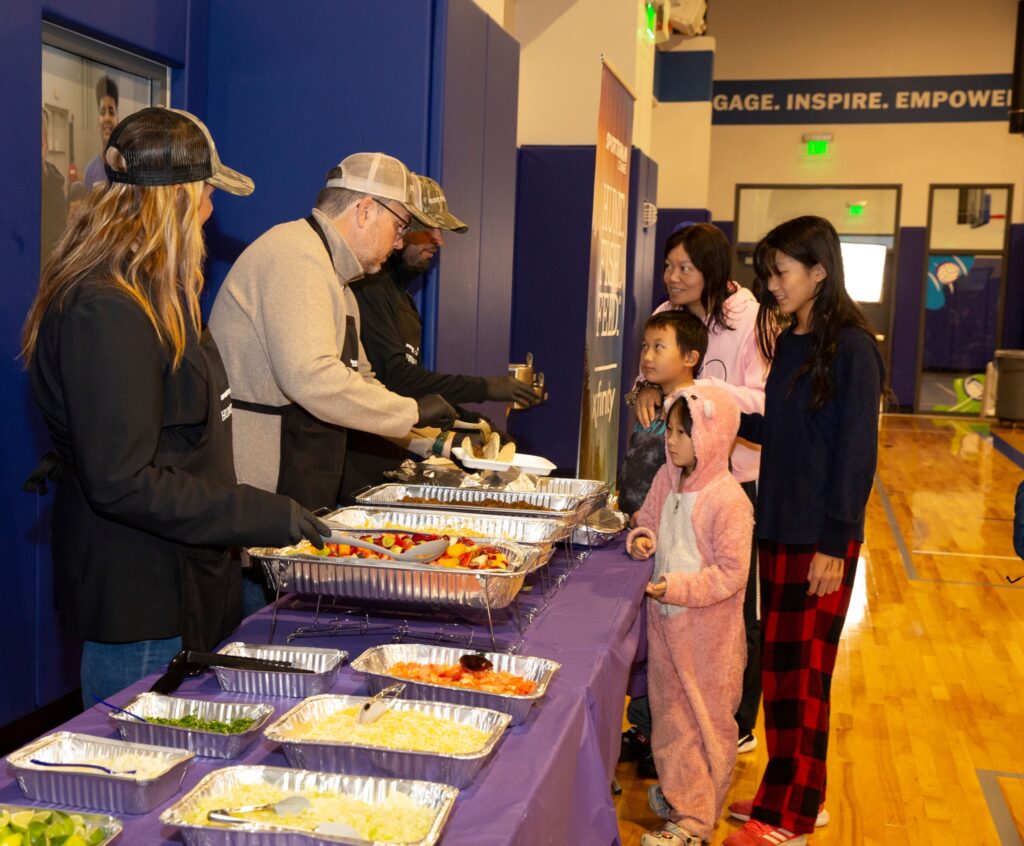 Families enjoying Hunt Fish Feed dinner